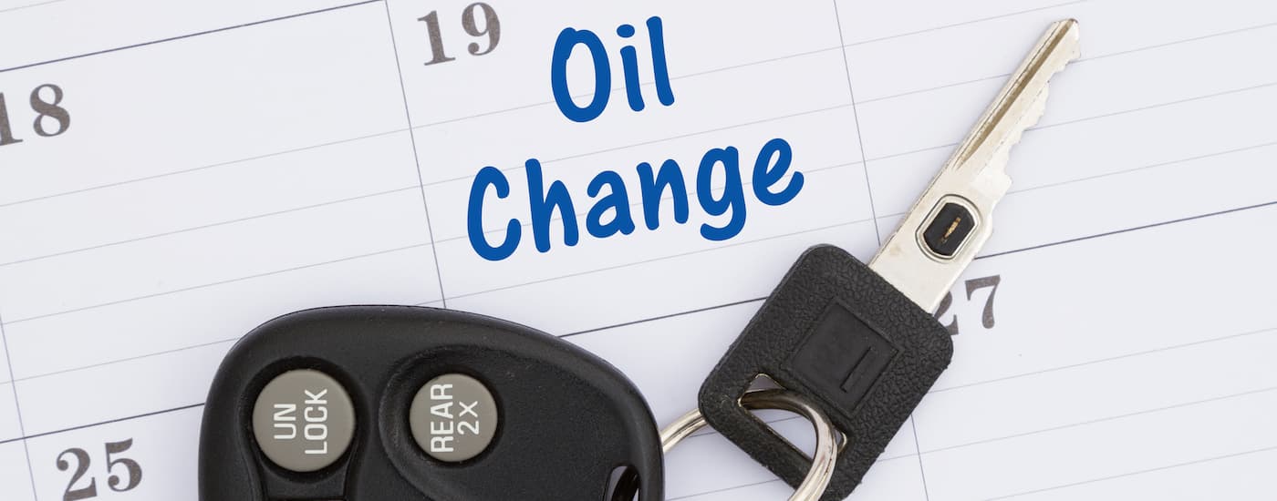 A calendar entry is marked "oil change" with car keys on top.