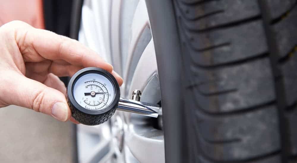 A close up of a tire's pressure being checked at the Cincinnati, OH, tire shop.